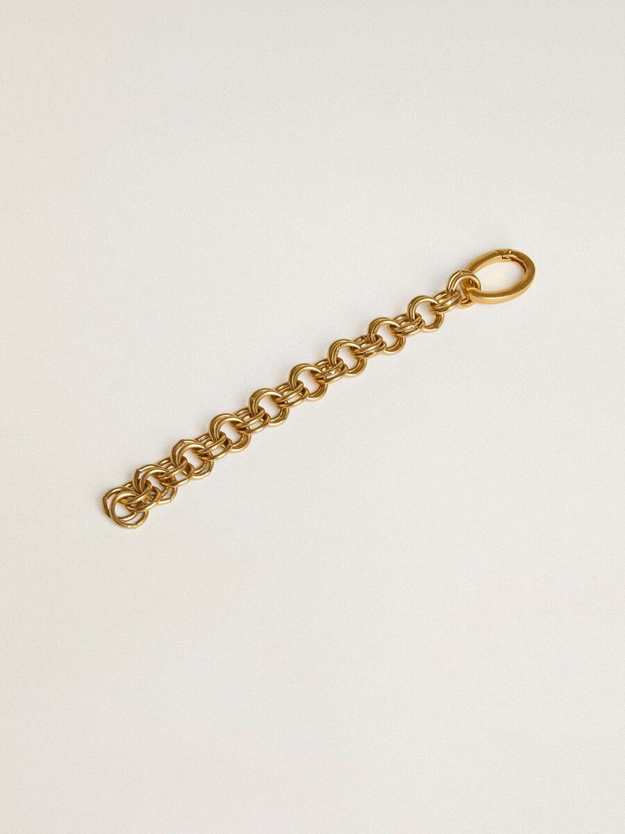 pingente antigo em latão dourado em formato de corrente.