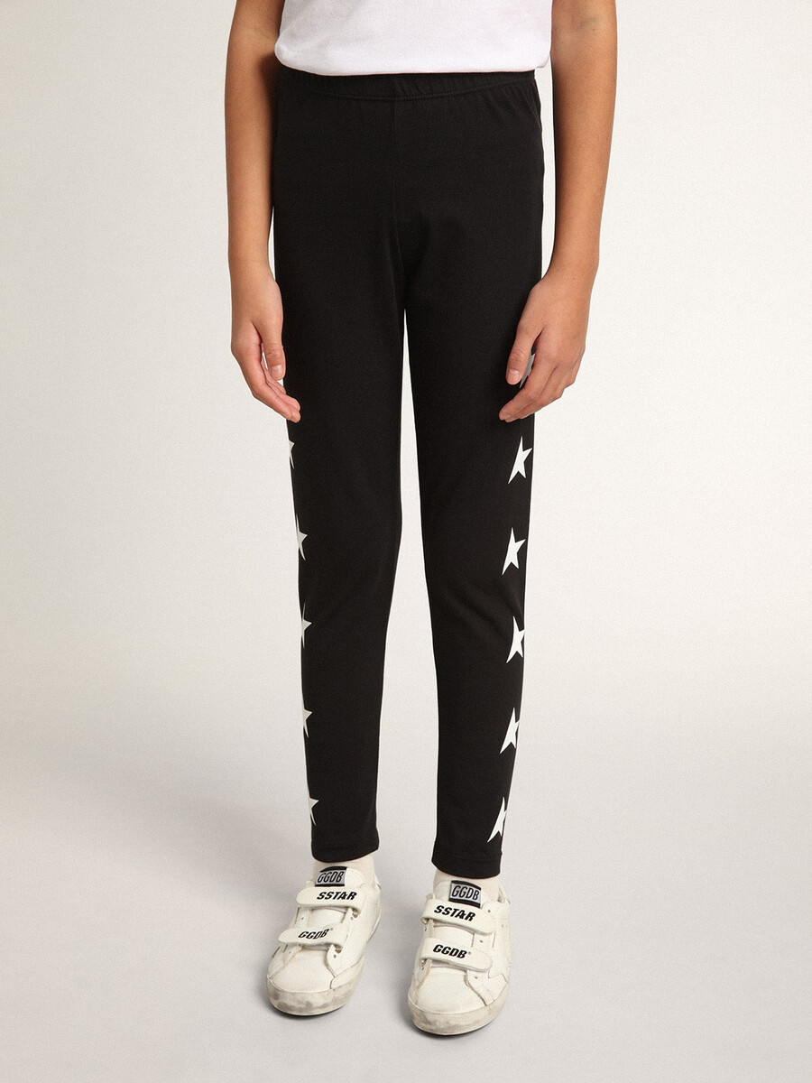 leggings pretas infantis com estrelas brancas nas laterais.