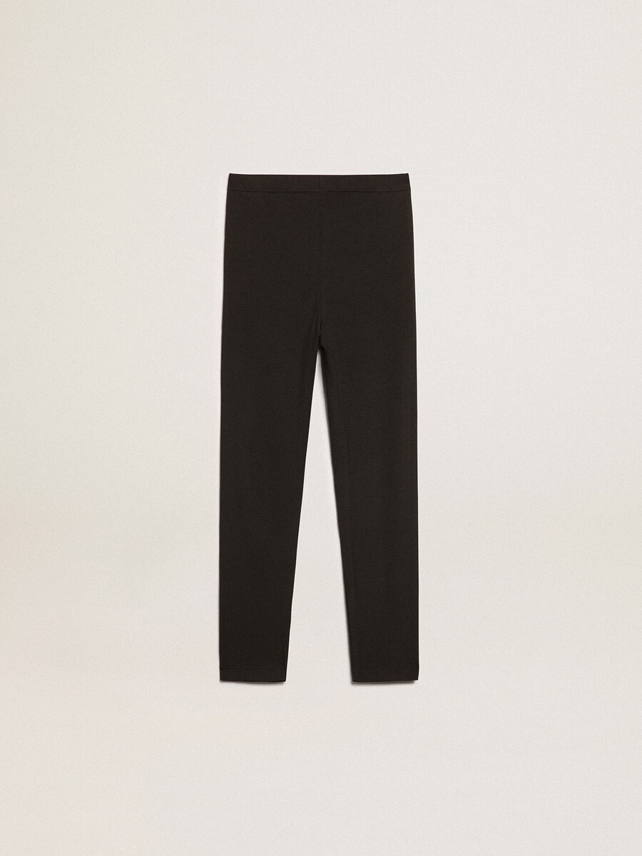 leggings pretas infantis com estrelas brancas nas laterais.