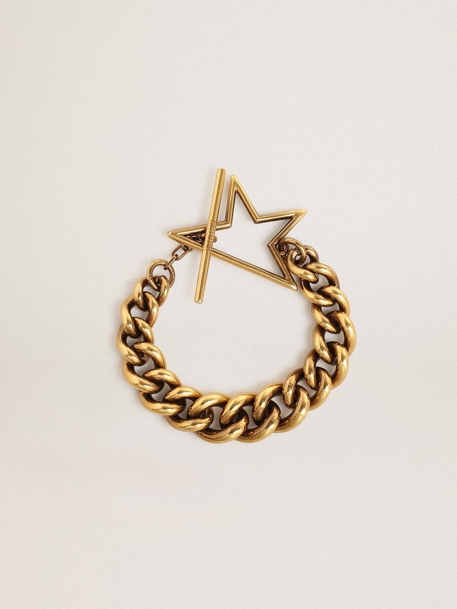 pulseira em corrente decrescente em ouro antigo com fecho em forma de estrela.