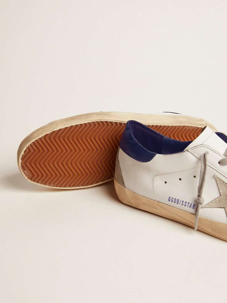 tênis masculino super-star com estrela de camurça e detalhe azul no calcanhar.