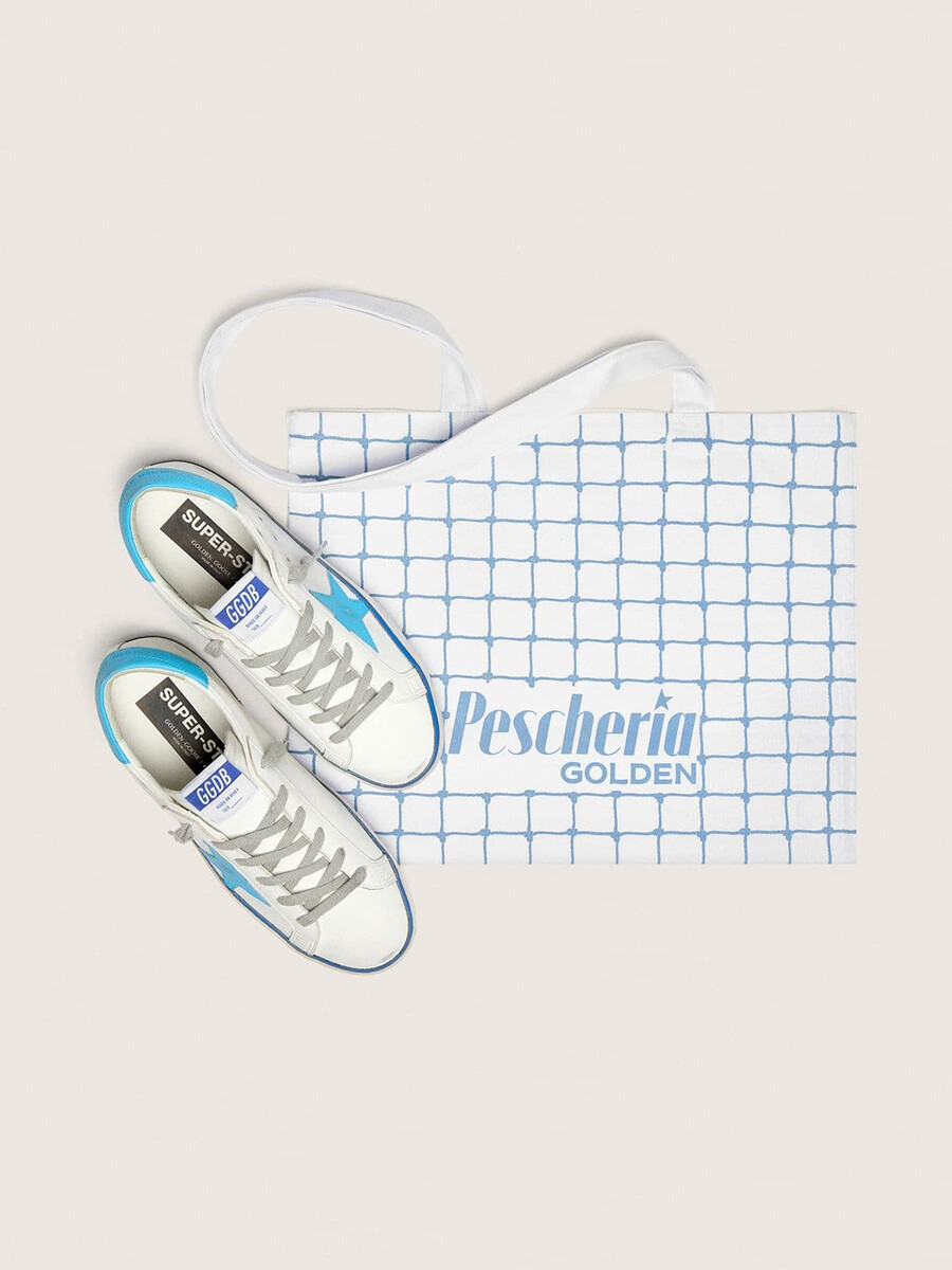 tênis super-star ltd feminino em couro branco com estrela em couro azul claro e detalhe no calcanhar.
